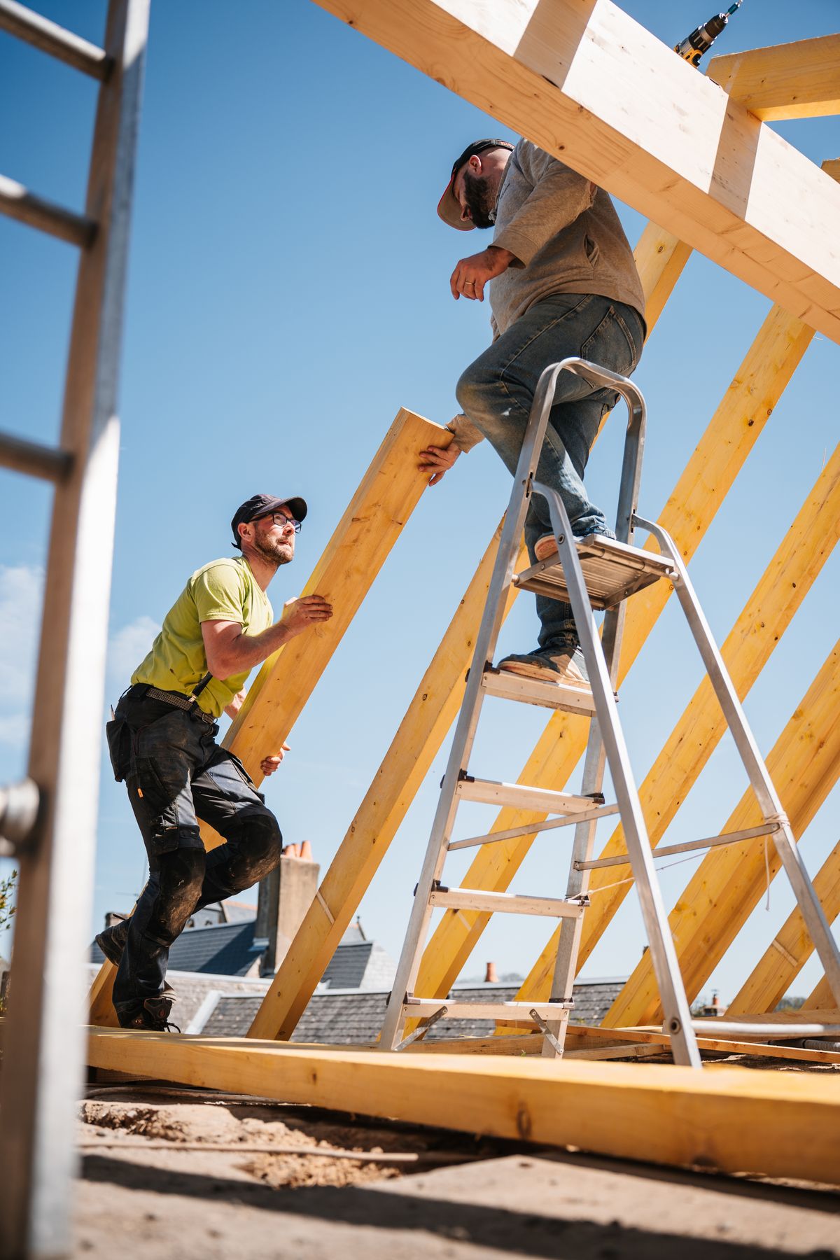 Carpenters assembling the timber framework of a new roof